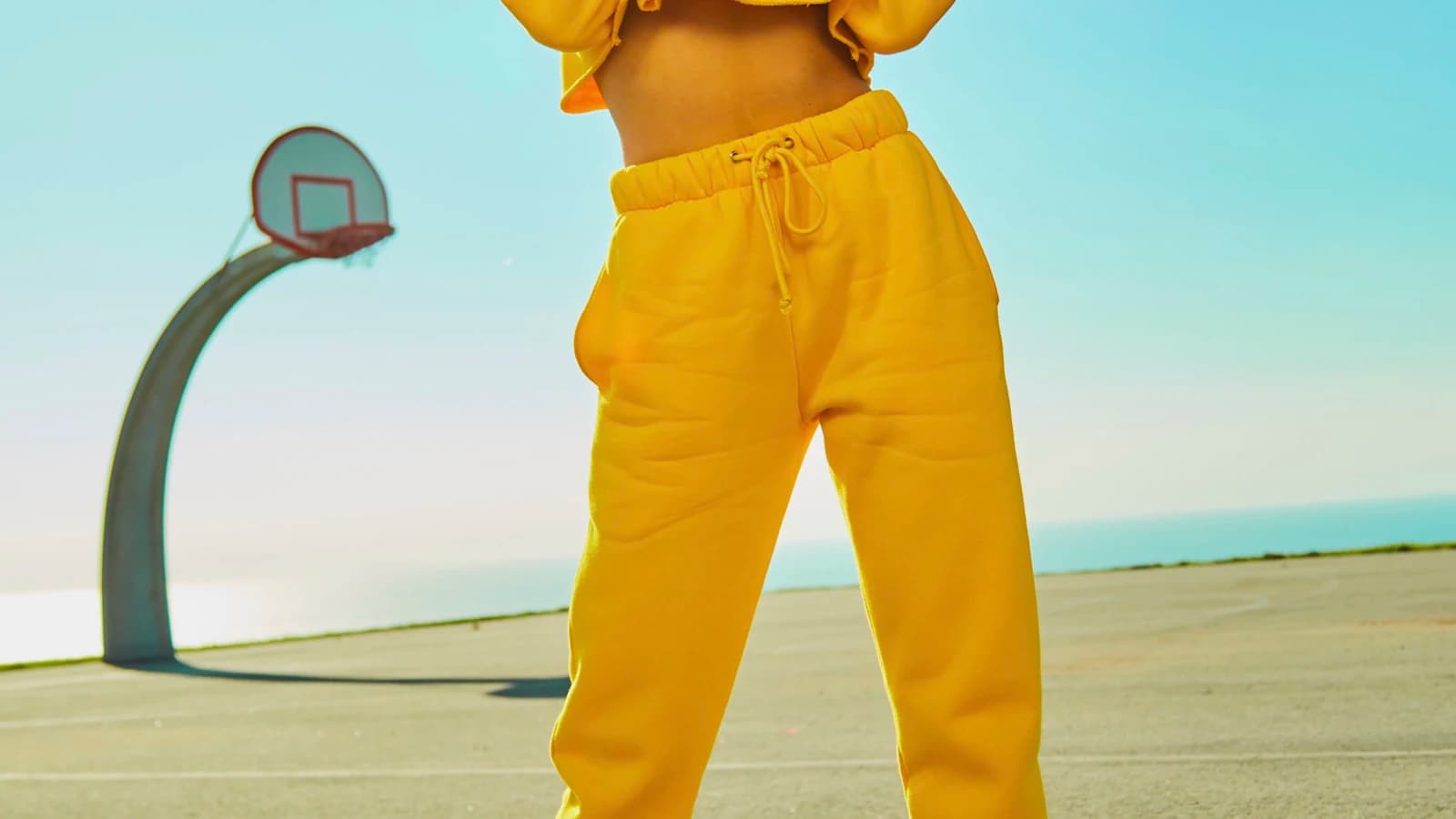 A yellow sweatsuit against a pale sky