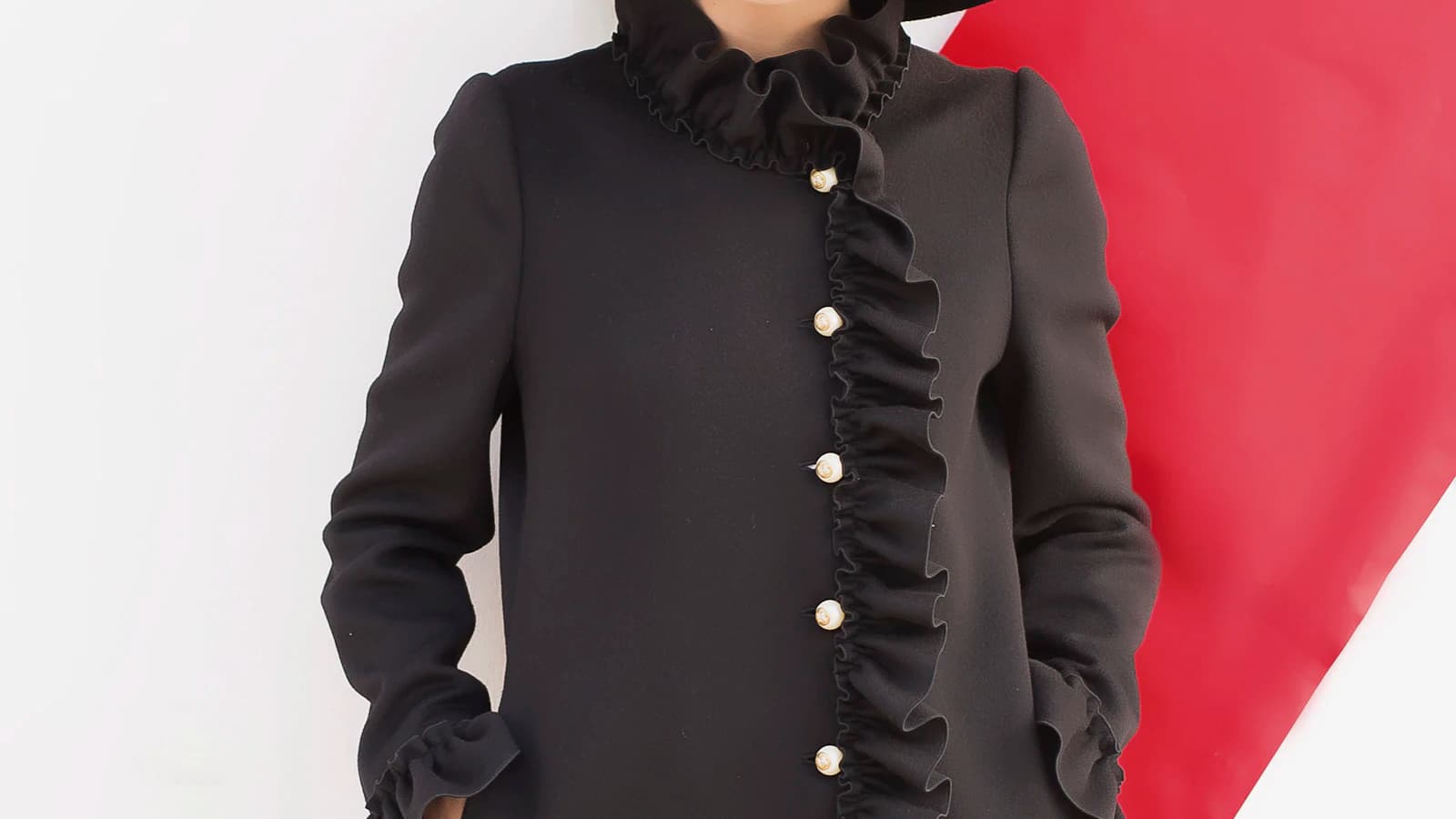 A long black coat and wide-brim hat
