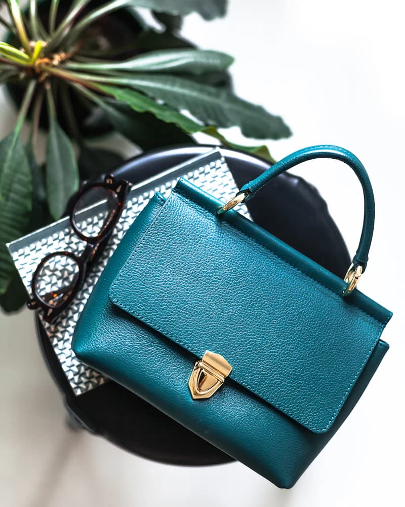 A teal top-handle bag